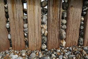 Flint pebbles in wooden groyne at cromer, norfolk